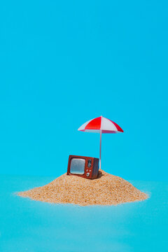 a retro television under a beach umbrella