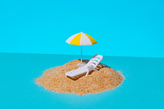 a tiny beach setup on a blue surface