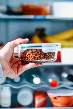 a man takes lentils from the fridge