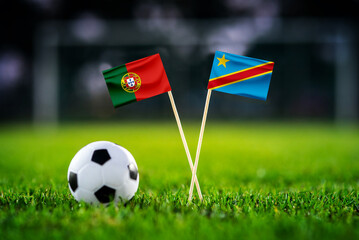 Naklejka premium Portugal vs DR Congo, national flags before world championship Group K group stage match, football on green pitch with goal in the background, Houston, USA, June 17, 2026
