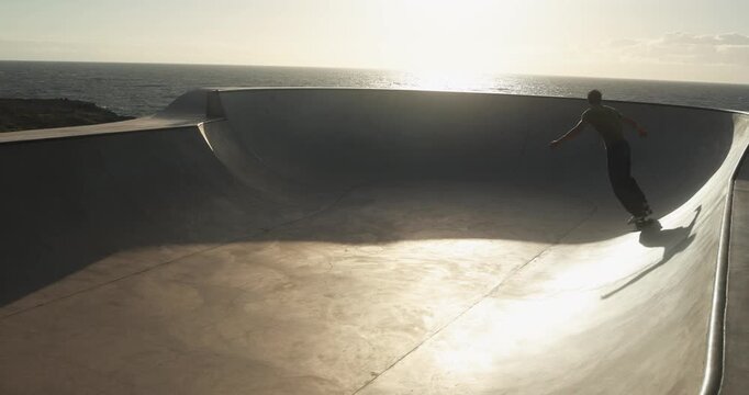 Young person having fun at skateboard park outdoor during summer time - Sunset, skater boy lifestyle and extreme sport concept 