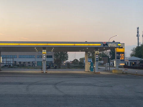 Eni gas station with fuel price board during early morning light, energy industry infrastructure