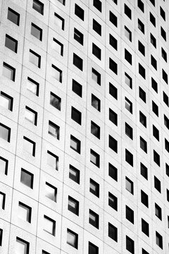 Abstract monochrome pattern on modern architecture facade windows with grid repetition texture creating a clean building exterior detail