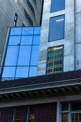 Obraz premium Contrast of historic brick building and modern architecture in Melbourne city