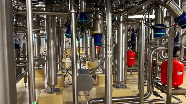 A Complex Network of Pipes and Industrial Equipment, Featuring Various Sensors and Red Pressure Tanks - Close Up