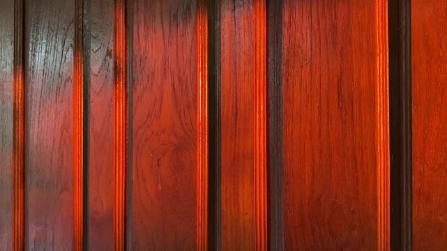 Elegant reddish brown wood panel background with beautiful natural grain texture.