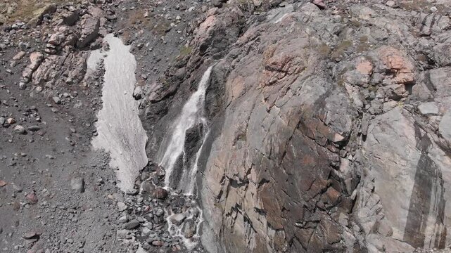 Caucasus, North Ossetia. Genaldon Gorge. Waterfall on a rocky slope.