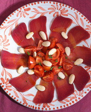 La moixama. Mojama or Mosciame, Spanish and Sicilian dried tuna served with tomatoes, almonds, and olive oil. A gourmet dried fish