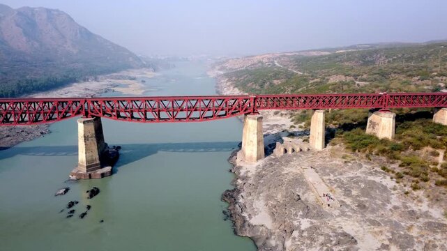 Attock red rail bridge drone view over river in Pakistan