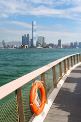 Fototapeta premium Hong Kong skyscraper panorama on a sunny day with water and boats