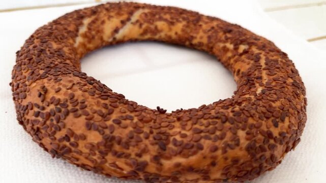 Turkish Simit Sesame Bagel Close Up Traditional Street Food Crunchy Bread on Table Surface, Close Up Video