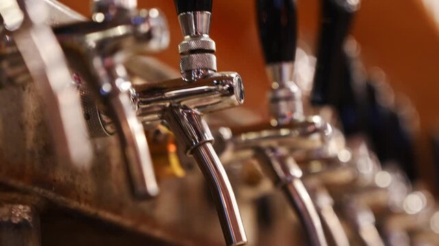 Selective focus on stainless steel beer taps with camera movement