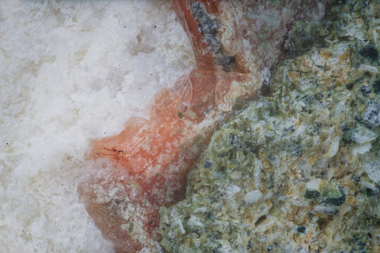 Macro image of heulandite white, stilbite orange, chlorite green zonal crystal arrangement from Vivi River, Evenkia, Russia, via microscope, 12x magnification, 3mm field of view