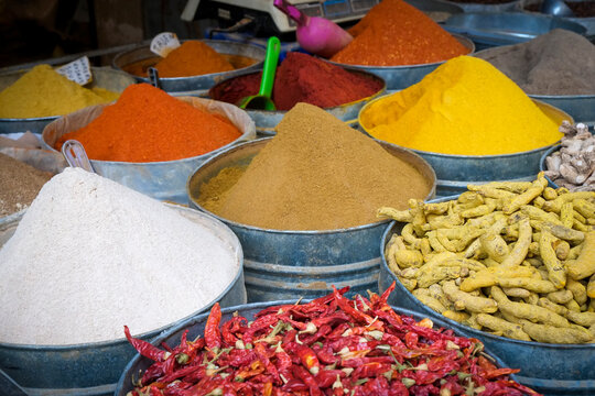 Colorful spices in bowls at market stall
