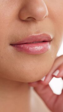 Cosmetics, beauty or lips of woman in studio for dermal filler, synthetic hyaluronic acid or results. Dermatology, person and mouth closeup on white background with HA treatment, lipgloss and volume