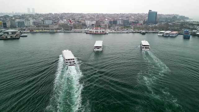 Istanbul/Turkey circa 2023: Ferries arriving at the Kadikoy ferry terminal