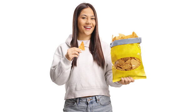 Happy young woman eating tortilla chips