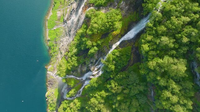 Seven Sisters Waterfall, Geiranger Fjord, Norway. Nature in fjords. Traveling through the Norwegian fjords. Scandinavia. View of nature from the drone. Vacation and travel in summer Norway.