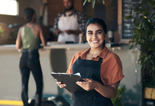 Waitress, clipboard and portrait with woman in restaurant for small business, menu planning and smile. Entrepreneur, cafe shift roster and hospitality with person at coffee shop for catering