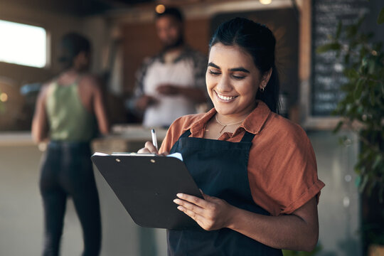 Waitress, clipboard and writing with woman in restaurant for small business, menu planning and startup. Entrepreneur, cafe shift roster and hospitality with happy person at coffee shop for catering