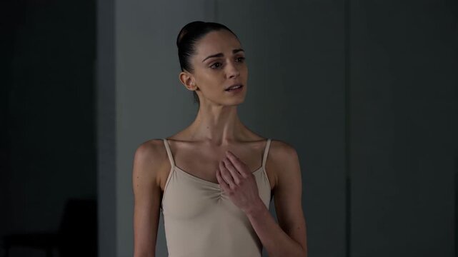 Graceful Ballerina Expressing Profound Emotions and Thoughtful Reflection in a Serene Rehearsal