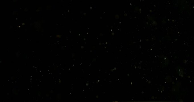 Super slow motion of airborne sand and dust particles, filmed at 500 fps on a high-speed camera. Isolated on black background, ideal as realistic VFX overlay.