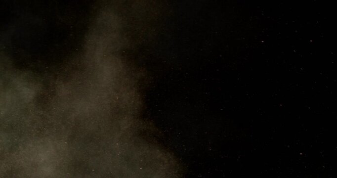 Super slow motion sandstorm and dust blizzard effect with airborne sand and fine particles, filmed at 500 fps on a high-speed camera. Isolated on black background, ideal as realistic VFX overlay.
