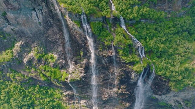 Seven Sisters Waterfall, Geiranger Fjord, Norway. Nature in fjords. Traveling through the Norwegian fjords. Scandinavia. View of nature from the drone. Vacation and travel in summer Norway.