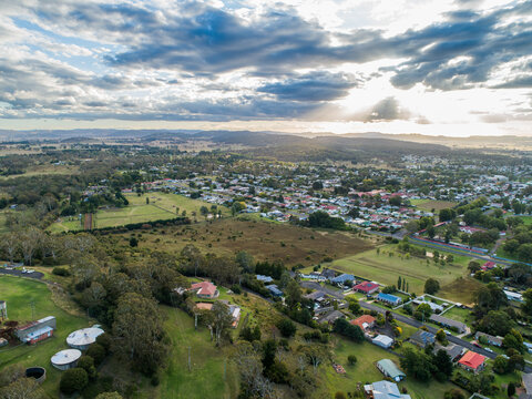 Sunrays through clouds in evening with view over town of Glen Innes in NSW Australia
