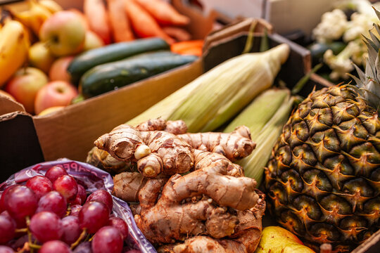 Ginger, grapes, pineapple and corn in box at fresh food hub