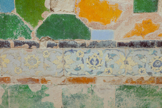 Close-up of authentic Safavid-era polychrome and mosaic tiles from the historic Farahabad Hammam in Sari, featuring intricate floral patterns and traditional motifs in blue, yellow, and green.