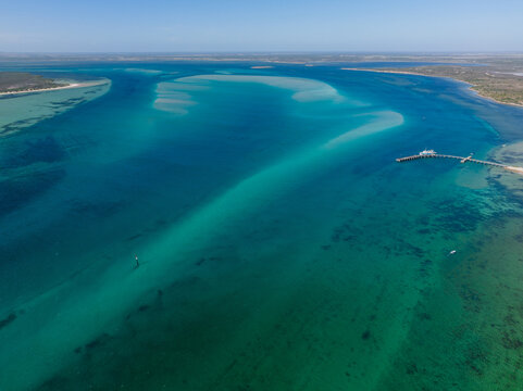 Aerial view of turquoise ocean channels running around a remote coastline