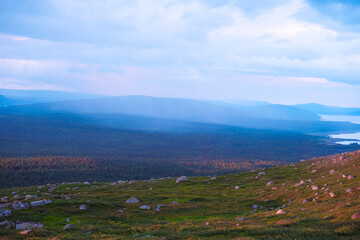 Fototapeta premium Majestic sunset over Kungsleden hiking trail in Laponia Sweden with golden light illuminating arctic tundra and mountain peaks