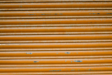 Fototapeta premium Orange metal shutter texture, industrial striped background