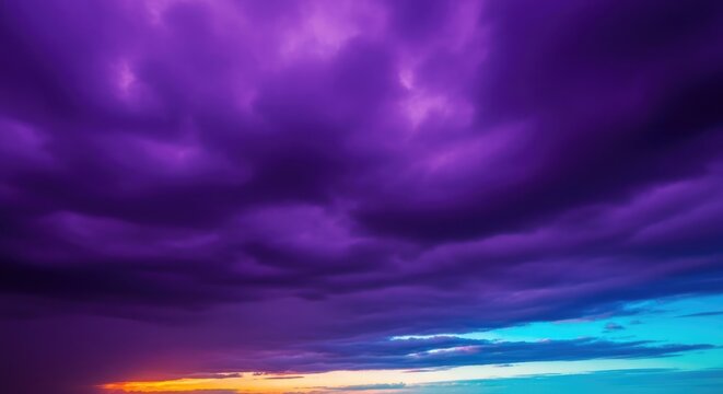 Vibrant purple clouds fill the sky during a dramatic sunset with orange and blue hues