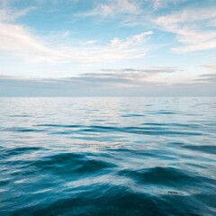 Obraz premium Blue sea and sky seascape with waves, clouds, horizon and sunlight over ocean beach view