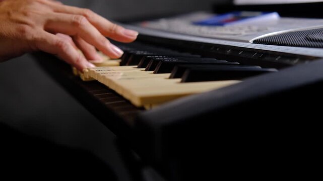 Close-Up of Hands Practice Piano Keyboard, music education, learning instruments.