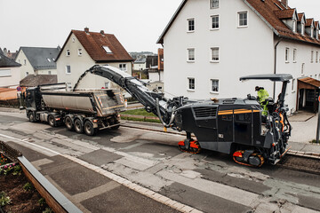 Road Milling Machine Removing Asphalt Surface for Urban Street Reconstruction and Infrastructure Maintenance © Katharina