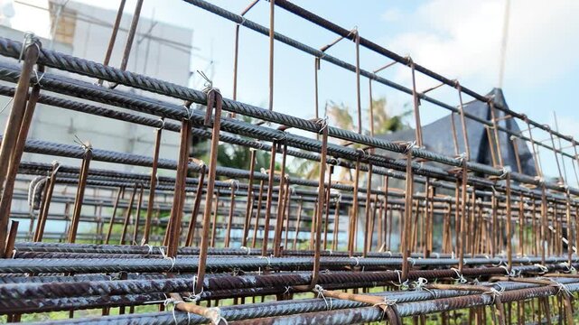 A detailed close-up of a robust steel rebar framework at a construction site.