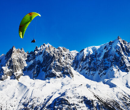 paraglider over a snowy mountainside in the French Alps, Chamonix, France, Europe