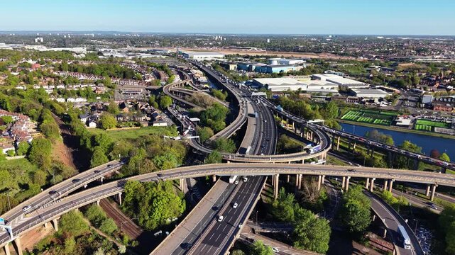 Aerial Drone View of Multi-Level Motorway Interchange Near Birmingham, UK, Traffic Flow on Sunny Day