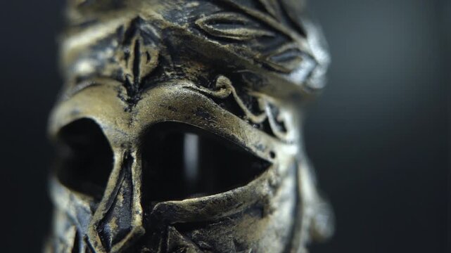 Cinematic macro of gladiator helmet rotating 360, wet surface and glowing light 120 FPS Slow motion