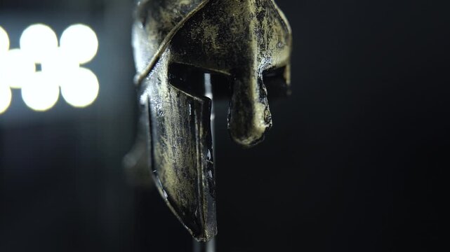 Slow motion rotating Spartan helmet, wet metallic surface, high detail macro shot 120 FPS Slow motion