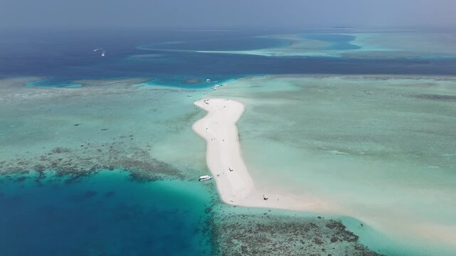 aerial drone view of lagoon with sandbank and turquoise water coral reef and boats