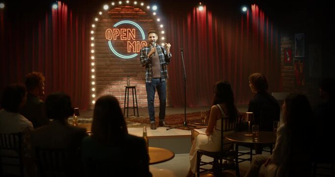 Male Comic Commands the Stage at a Bar Open Mic, Delivering Sharp Stand-up Jokes, Playful Crowd Work and Lively Storytelling as the Audience Laughs and Applauds Through the Night.