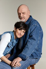Fototapeta premium Two hearts intertwine in a tender embrace, celebrating love in their golden years