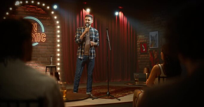 Male Comedian Leads a Live Comedy Club Stage Performance at Open Mic Night, Telling Funny Jokes as the Audience Is Having Fun in a Bar Venue Entertainment Show
