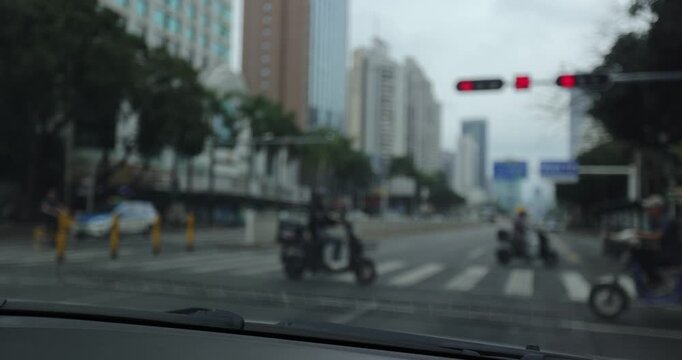 Driving car on city road in downtown of shenzhen city, China