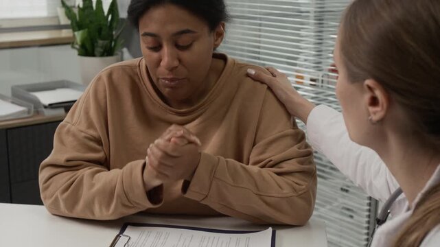 Fertility specialist comforting female patient feeling upset about results of ultrasound diagnostics while visiting IVF clinic