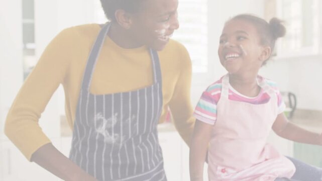 Mother guiding child reaching for dough on floured counter, sparking cooking lesson and flour marks